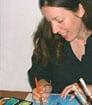 Female children's book author illustrating one of her picture books